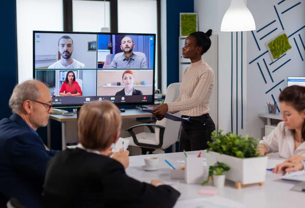 woman discussing with remote managers on video call presenting new partners on webcam.